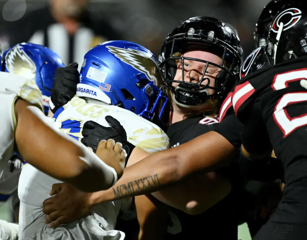 Santa Margarita running back Adrian Petero (26) is tackled by...