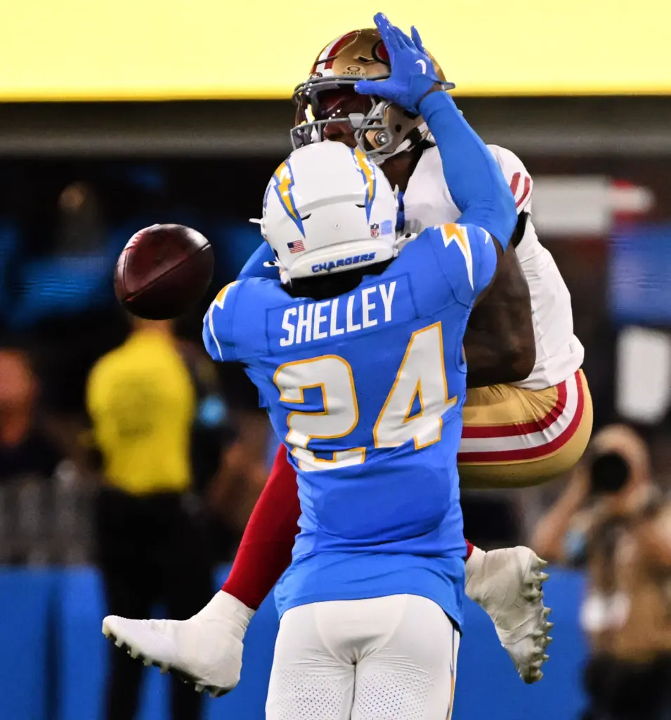 Chargers cornerback Rodney Shelley, front, knocks the ball away from...