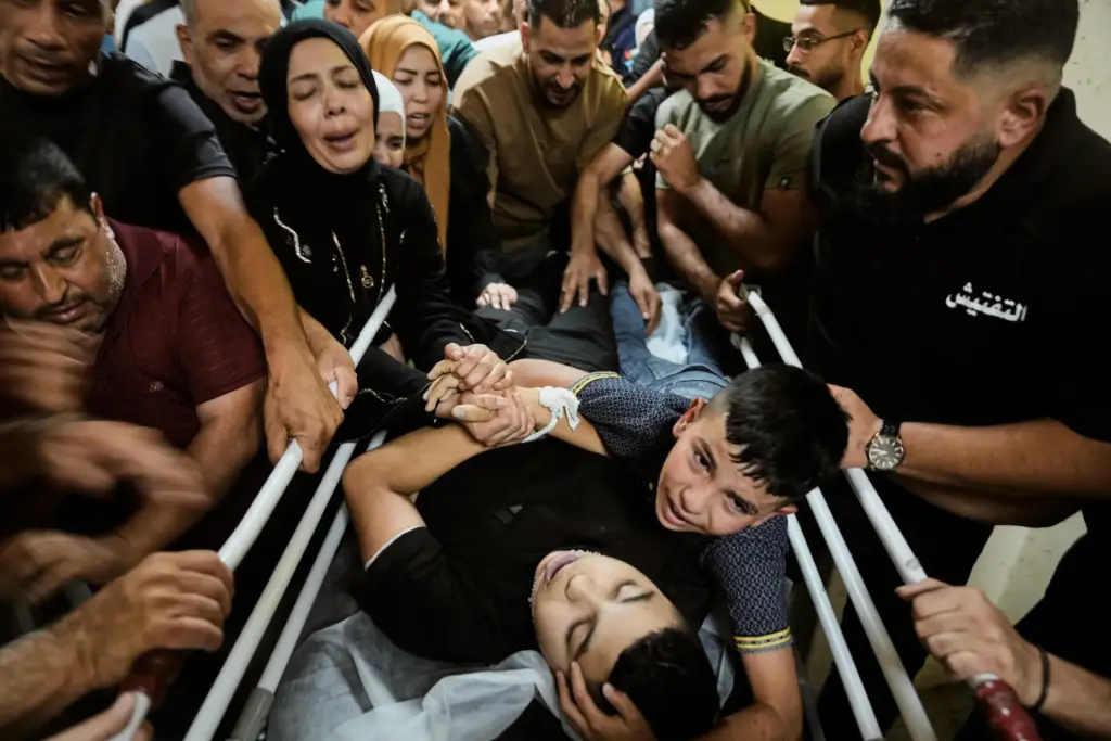 Mohammed Ajouri mourns over the body of his brother Islam...