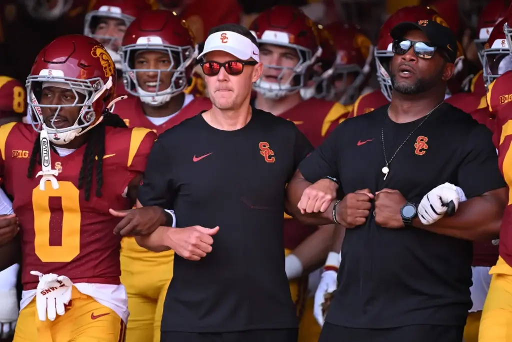 USC head coach Lincoln Riley walks onto the field with...