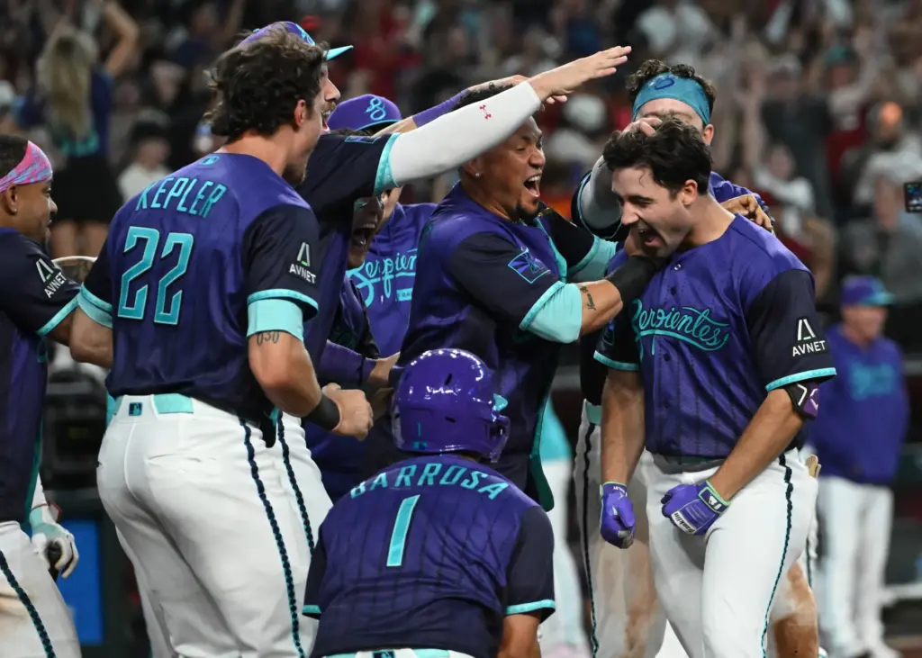 The Arizona Diamondbacks' Ryan Waldschmidt, right, is mobbed by teammates...