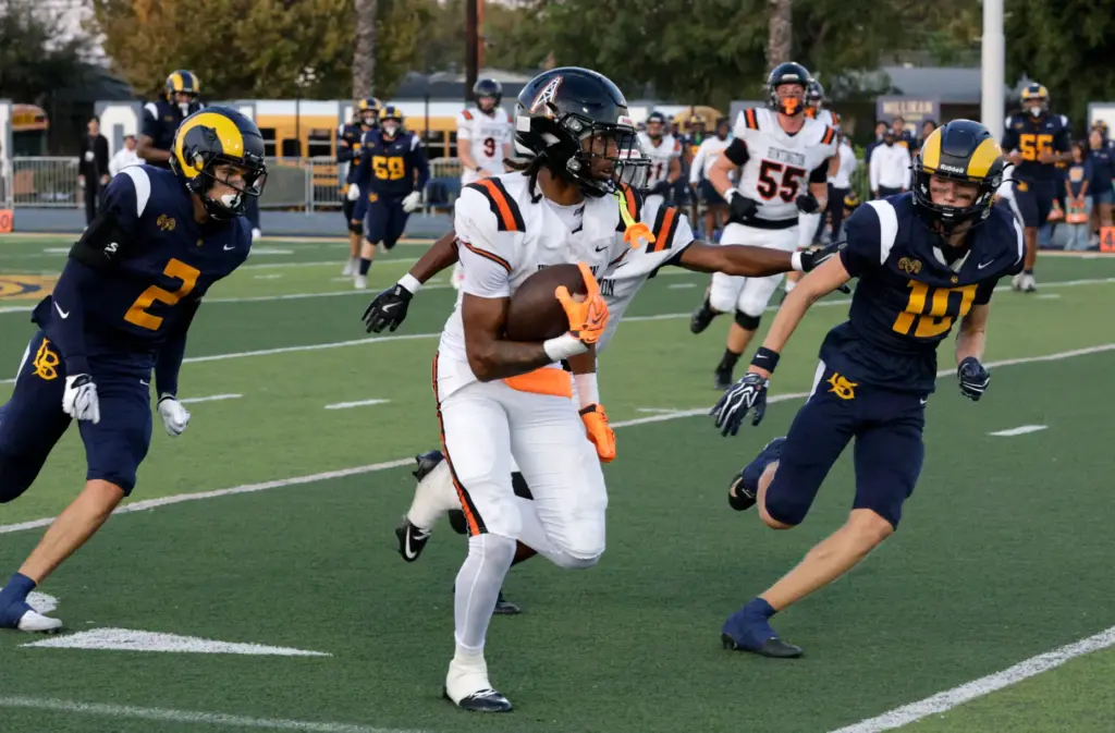 Milikans Josh Miyake (2) and Easton Cook (10) look to...