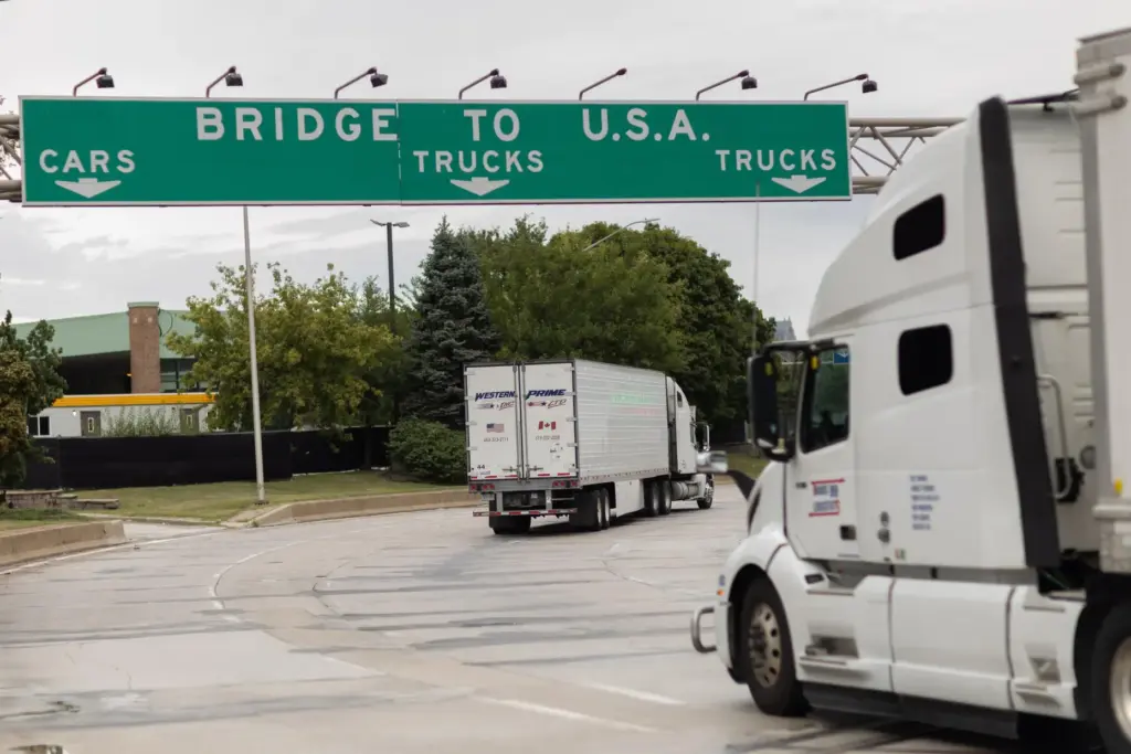 Transport trucks cross the Ambassador Bridge into the United States...