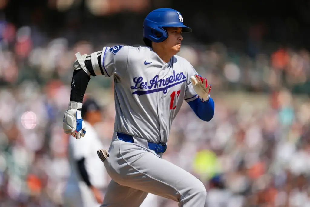 Dodgers’ player Shohei Ohtani runs out a ground ball against...