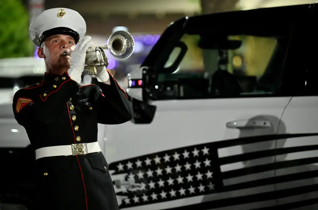 Marine Cpl. Brad Sadler performs taps at the Fallen 13...