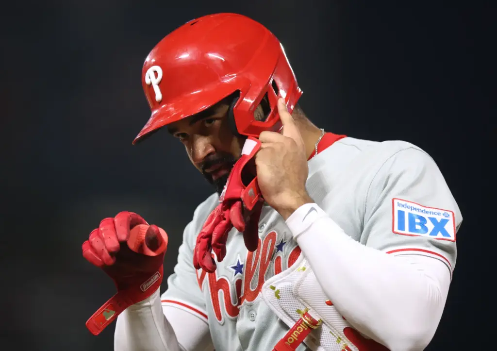 The Philadelphia Phillies’ Derek Hill reacts after his RBI bunt...