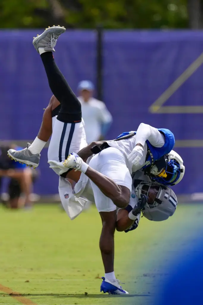 Rams cornerback Cam Lampkin, top, and Dallas Cowboys tight end...