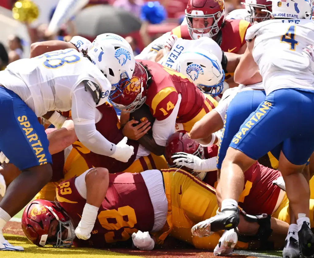 Quarterback Jayden Maiava (14) of the USC Trojans runs for...