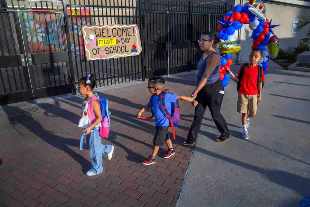 Nuri Perez walks with her children Mila, 5, Elliot, 4,...