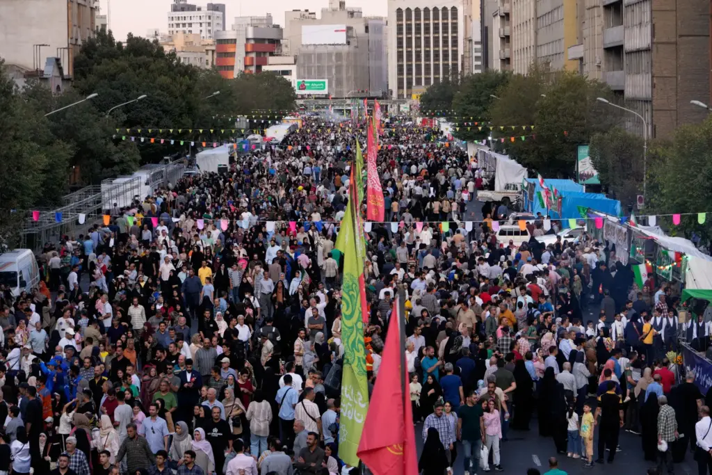 Crowds fill a street during celebrations marking Prophet Muhammad’s birthday...
