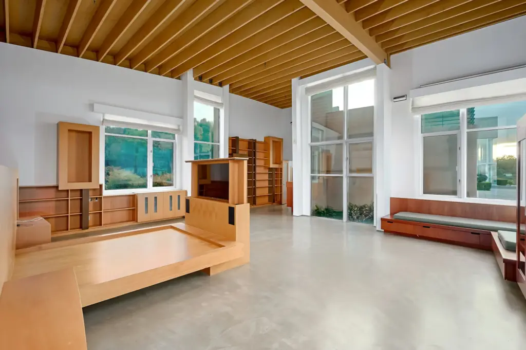 A view of the primary bedroom with its custom bedframe...