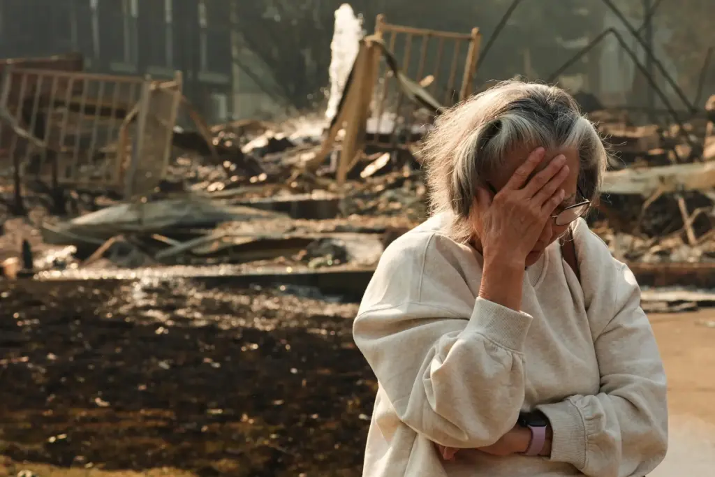 Miriam Sim, 76, reacts while talking about her neighborhood largely burning to the ground.