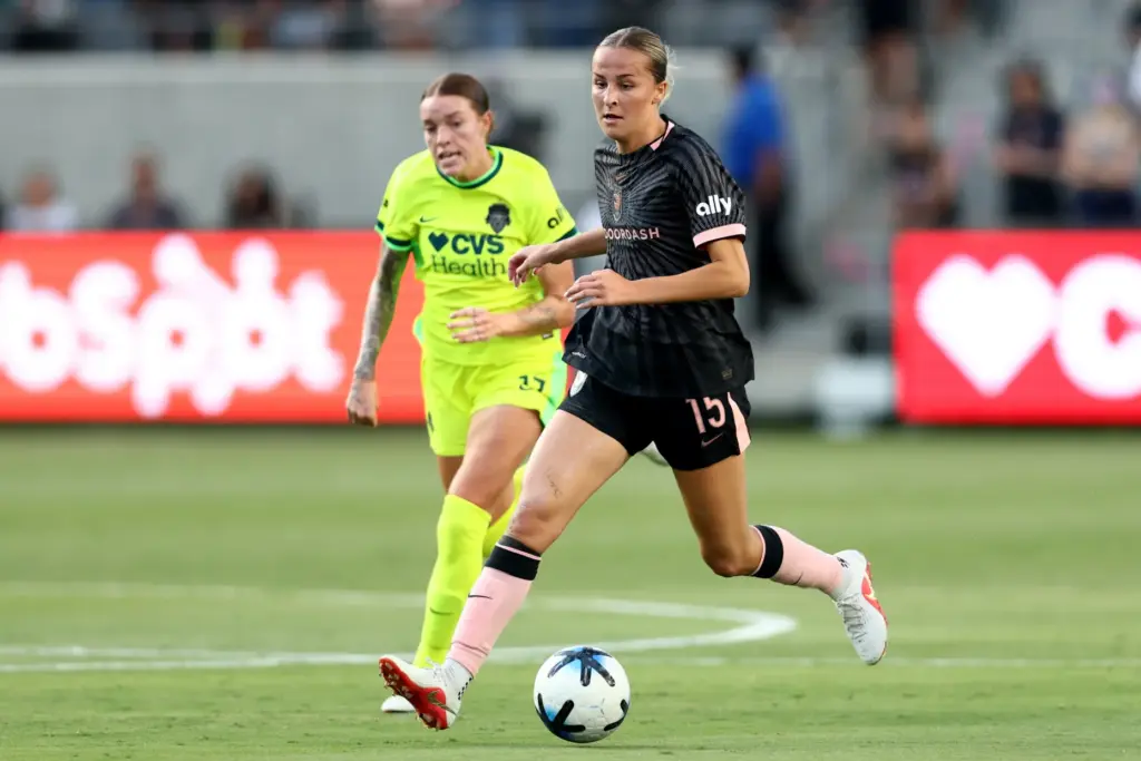 Angel City FC midfielder Evelyn Shores moves the ball chases...