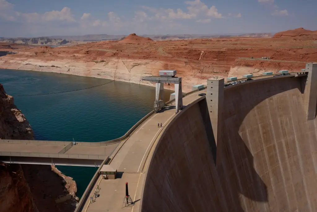 People walk across the Glen Canyon Dam near Lake Powell...