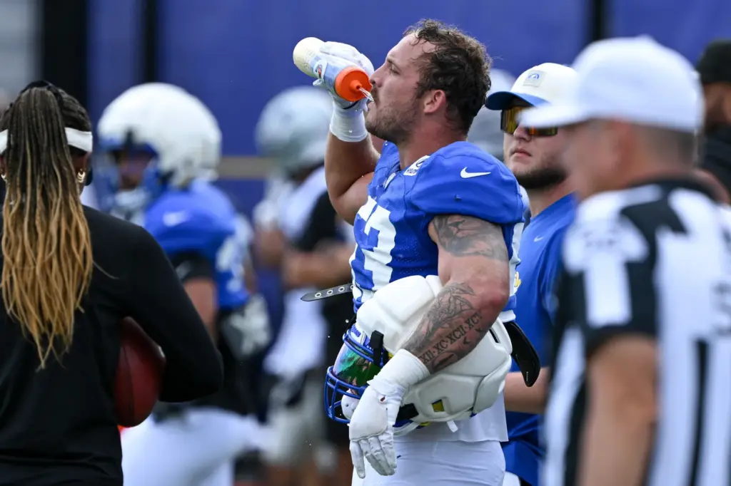 Rams linebacker Nate Landman stays hydrated during the team’s joint...