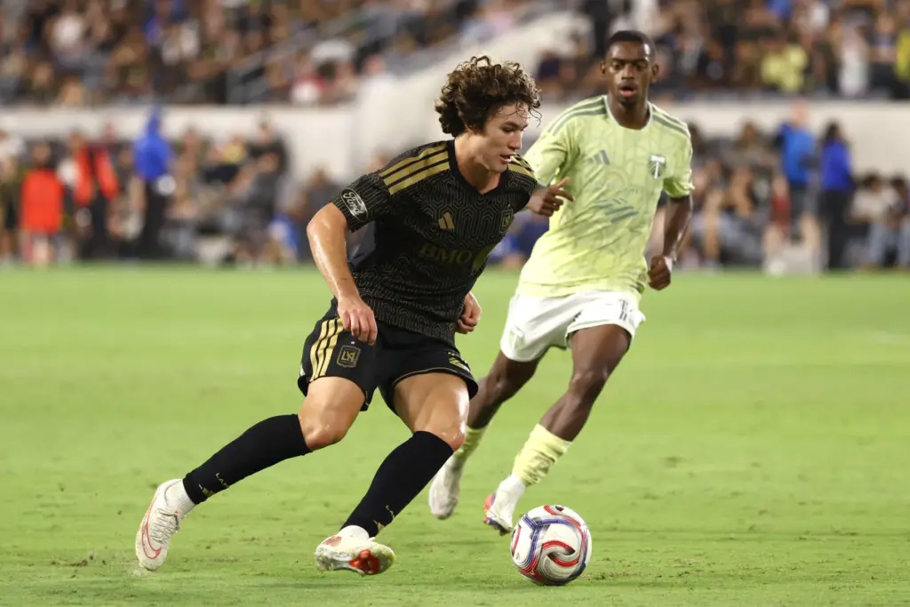 LAFC midfielder Jude Terry, front, moves the ball as Portland...
