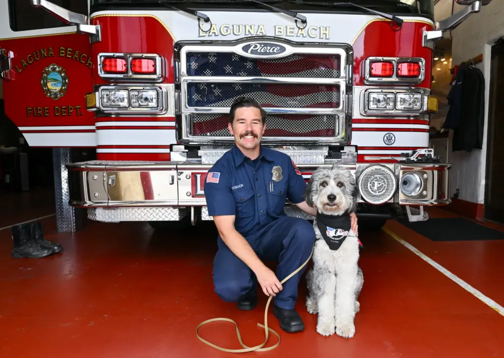 Laguna Beach Firefighter/Paramedic Logan Strook with Oro, a 2-year-old Aussiedoodle...