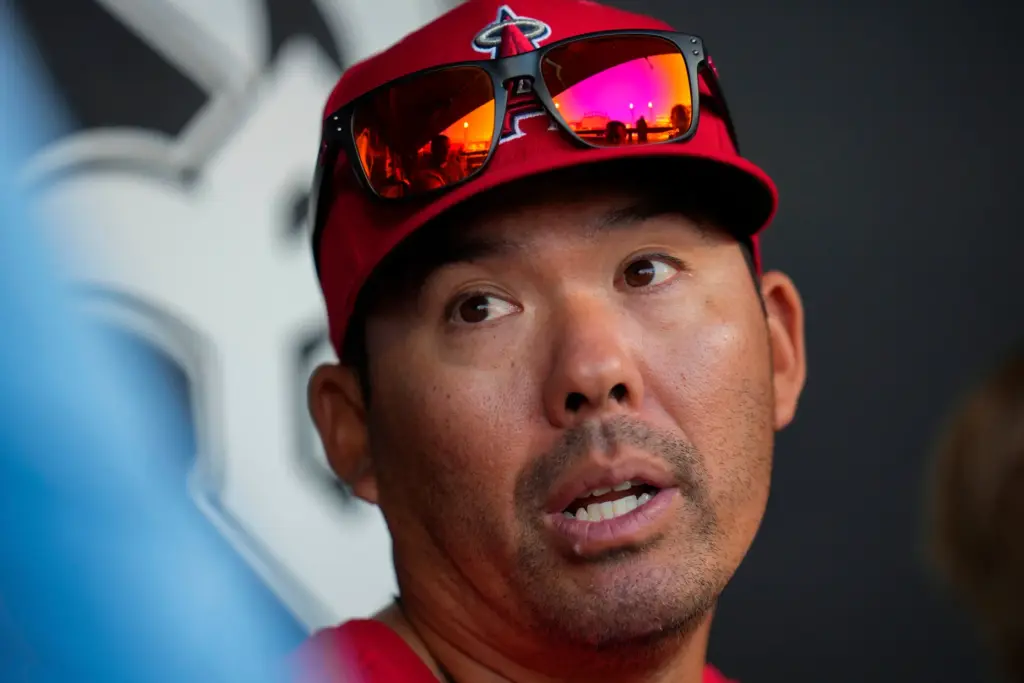 Angels manager Kurt Suzuki speaks with reporters before a baseball...