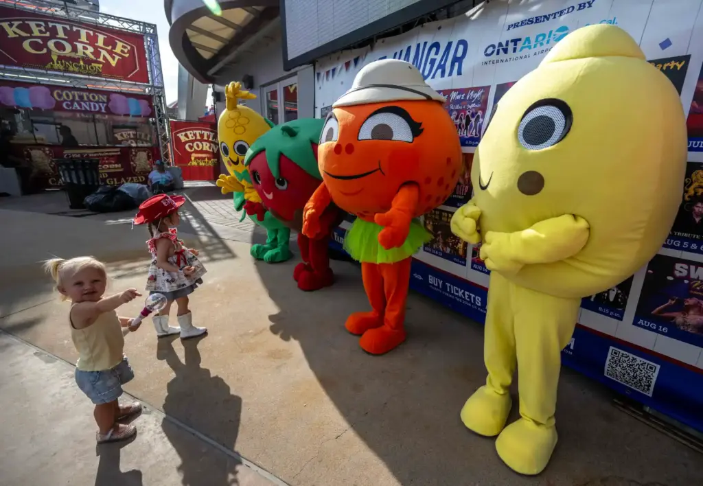 Kids greet the OC Fair mascots in front of The...