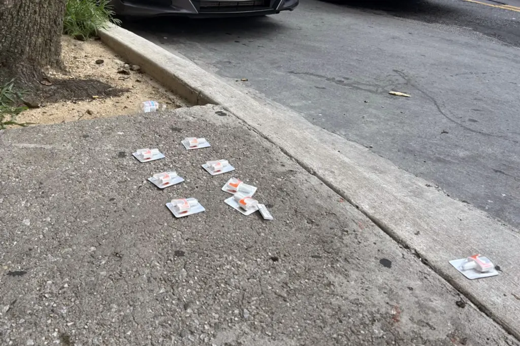 Naloxone, an overdose reversal drug, is spread out on a street corner.