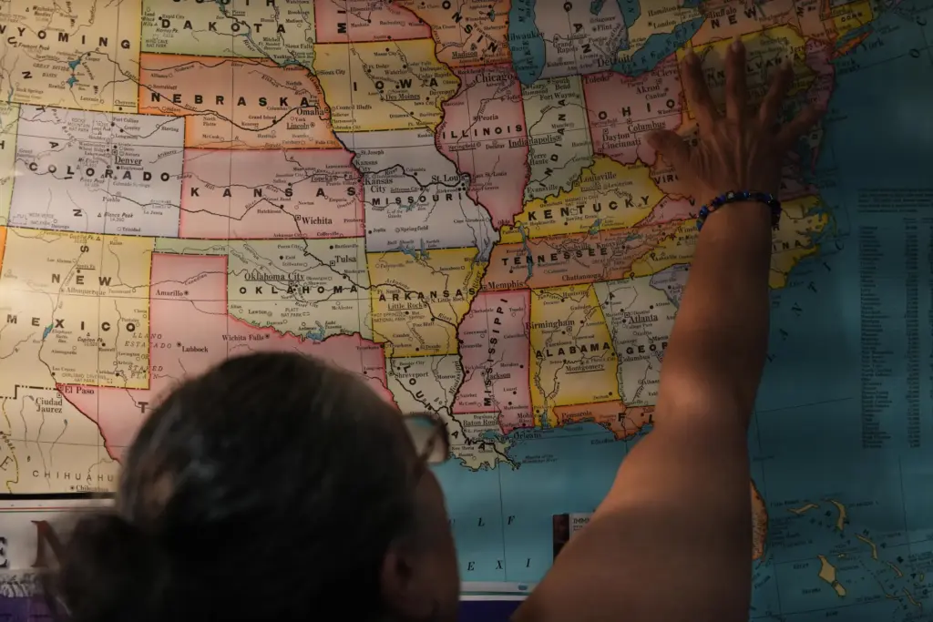 Leila Borrero Krouse points to a U.S. map in her office.