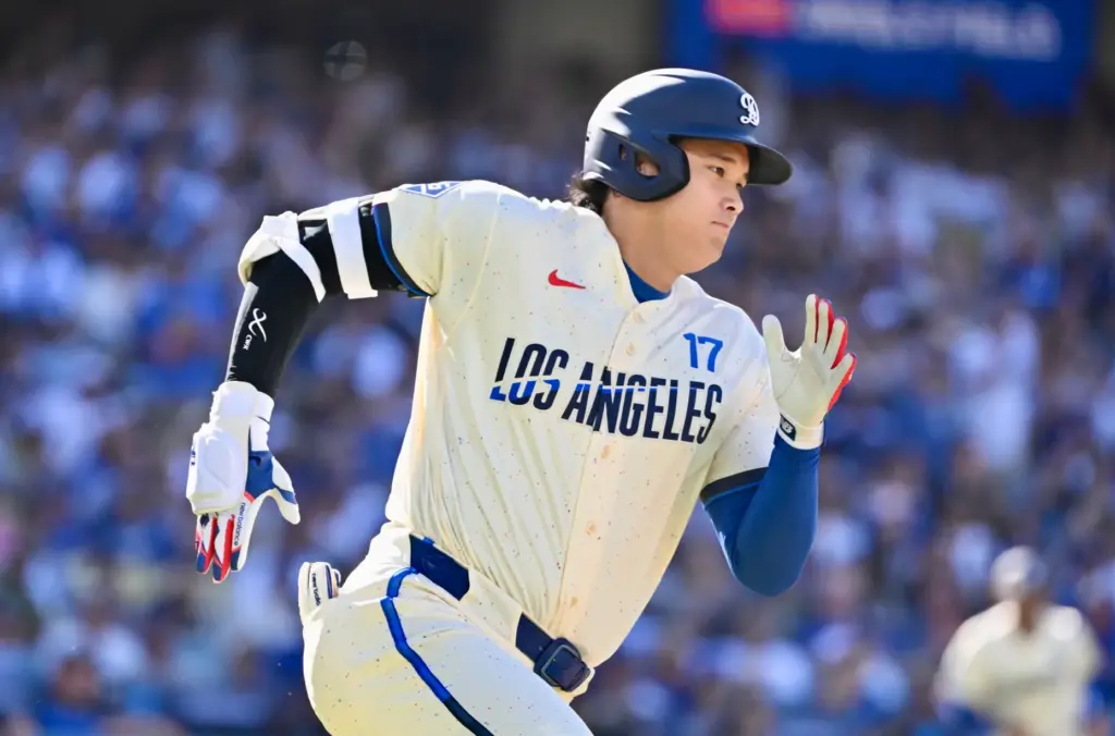 Shohei Ohtani of the Dodgers hits a RBI triple against...