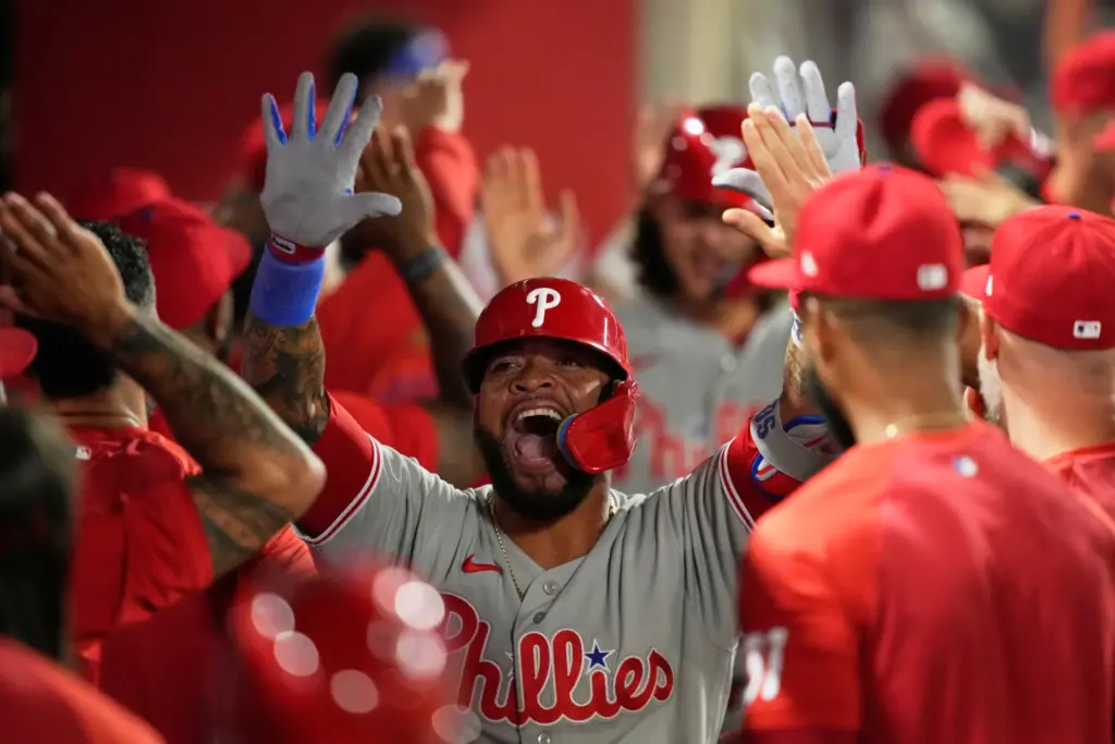 The Philadelphia Phillies’ Edmundo Sosa celebrates in the dugout after...