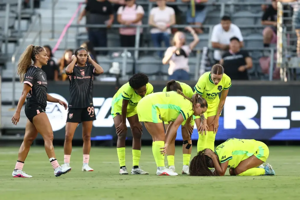 Washington Spirit forward Trinity Rodman, bottom right, crouches on the...