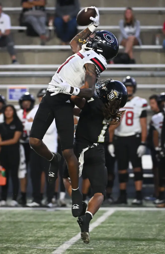Centennialâs Quentin Hale (1) leaps to complete a pass as...