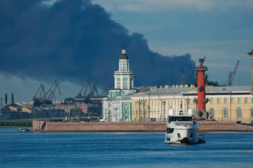 A plume of black smoke is seen over the port of St. Petersburg, Russia.