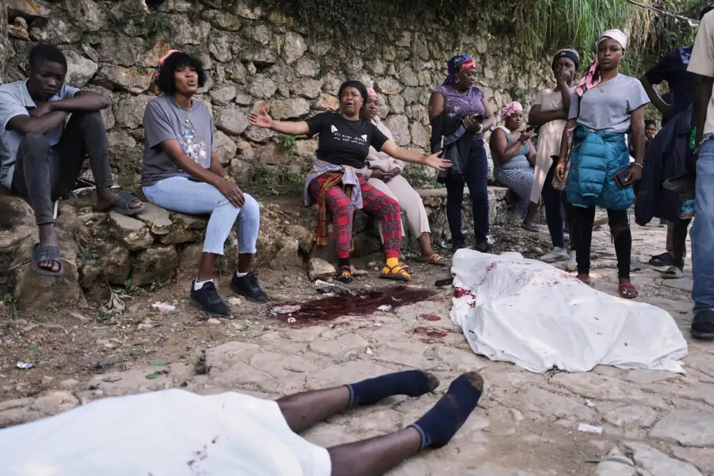 People gather next to the bodies of people they said...