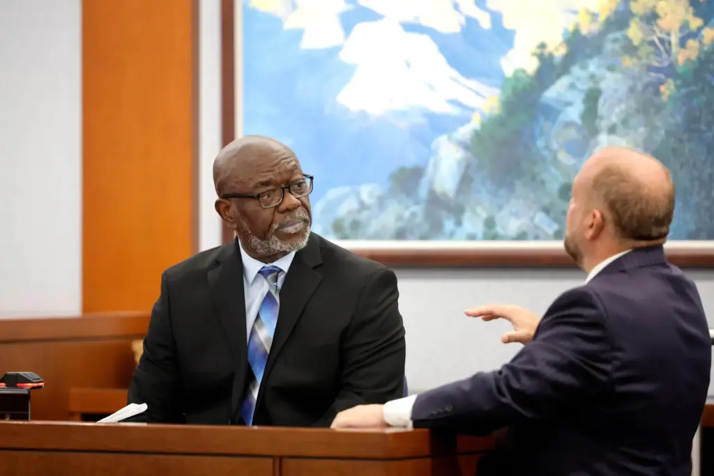 Former Las Vegas Metro Police officer Charlie Mangrum listens to Chief Deputy District Attorney Marc DiGiacomo.