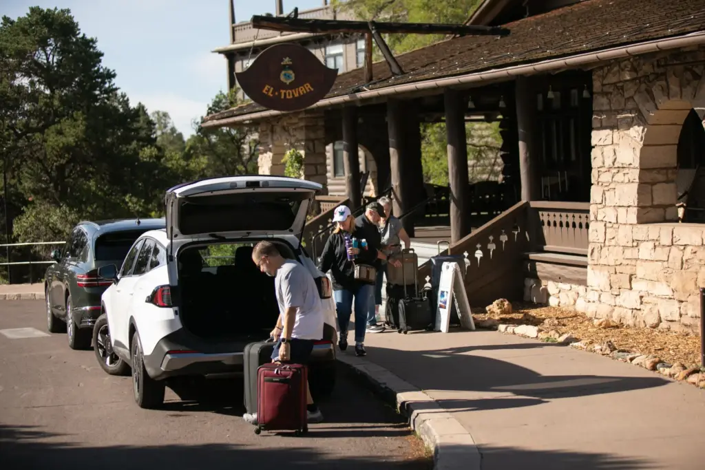 Tourists check out of the El Tovar Hotel as lodging...