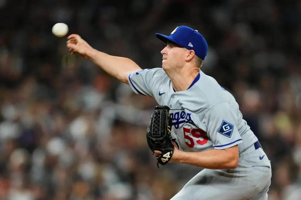 Dodgers pitcher Evan Phillips throws to the plate against the...