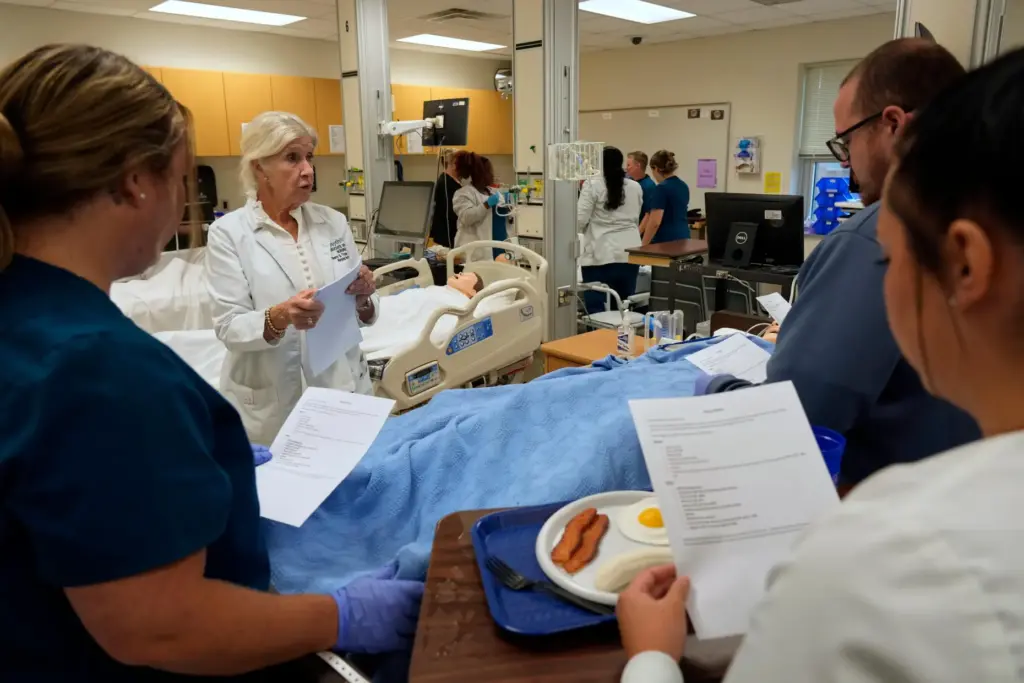 Nursing instructor Sherry Troop speaks to nursing students in the simulation lab.