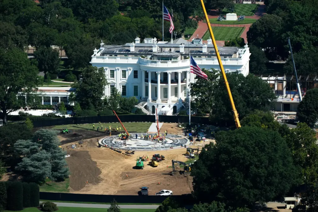 Workers build a helipad on the South Lawn of the...