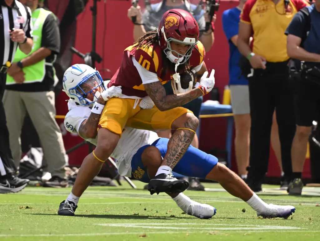 Wide receiver Corey Simms (10) of the USC Trojans catches...
