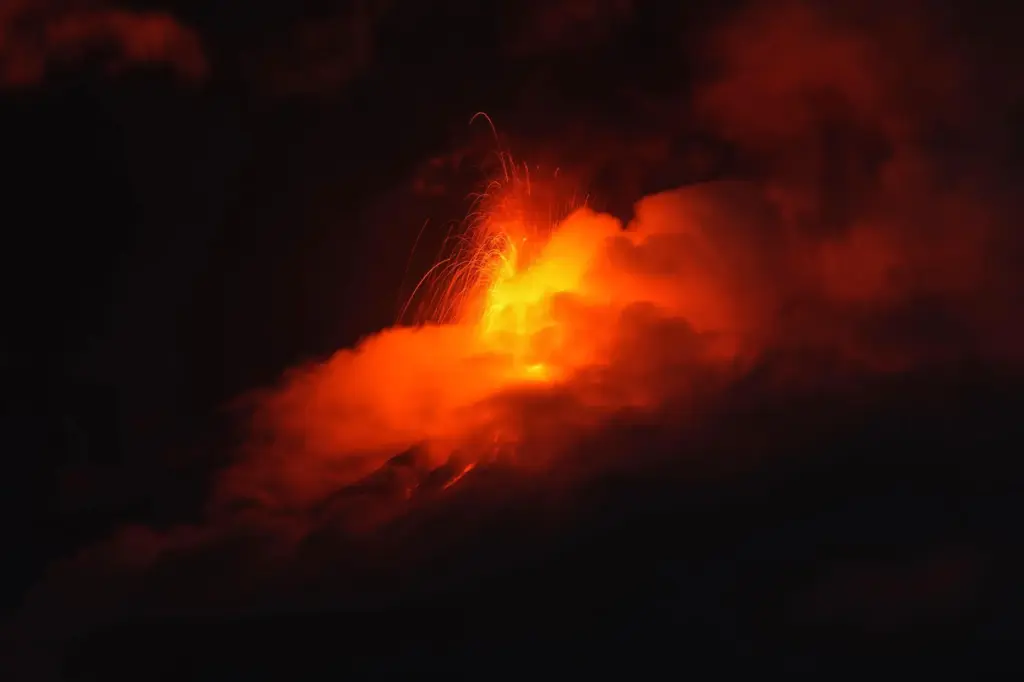 Lava flows out of the crater of the Fuego Volcano,...