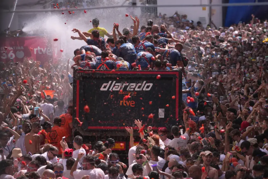 Revelers throw tomatoes at each other during the annual “Tomatina”...