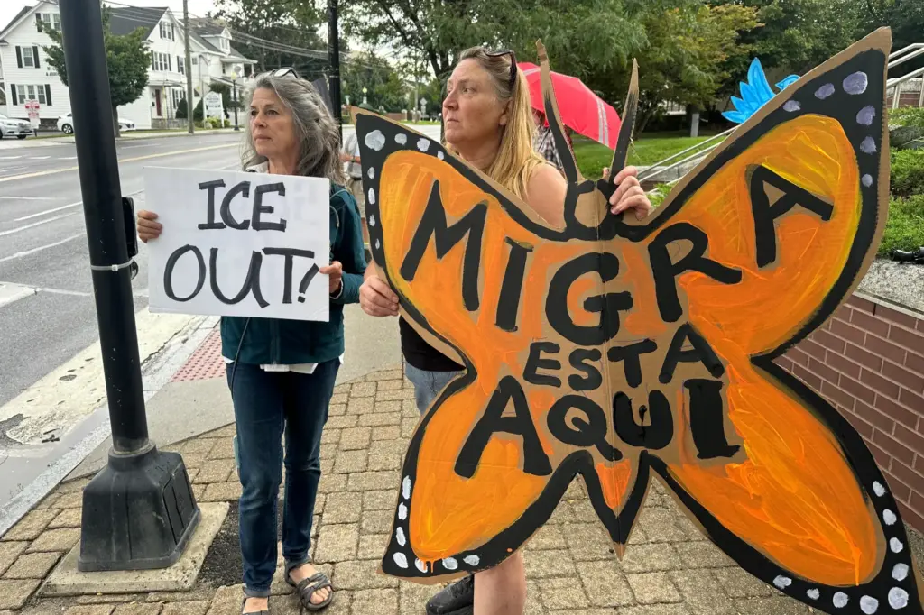 Anti-ICE activists Cheryl Harrington, left, and Julia Provey gather outside...