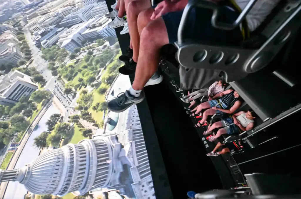 Riders fly over The U.S. Capitol during opening day of...