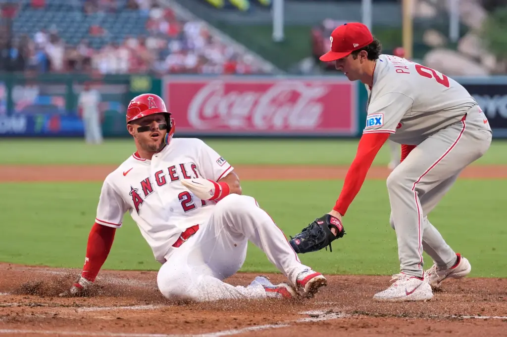 Angels star Mike Trout, left, scores on a wild pitch...