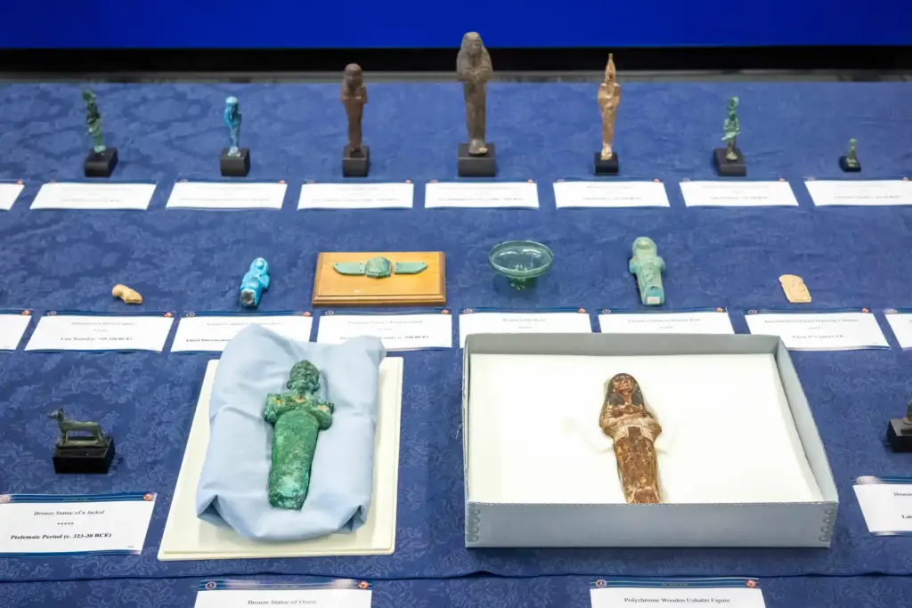 Dozens of looted Egyptian artifacts are on display during the...
