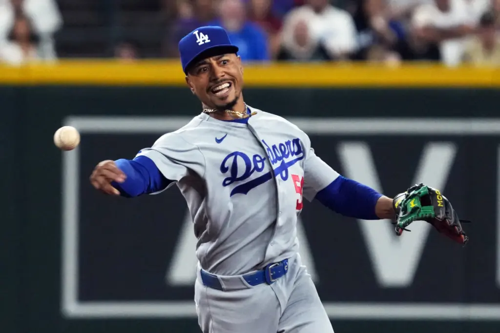 Dodgers shortstop Mookie Betts throws to first base on a...