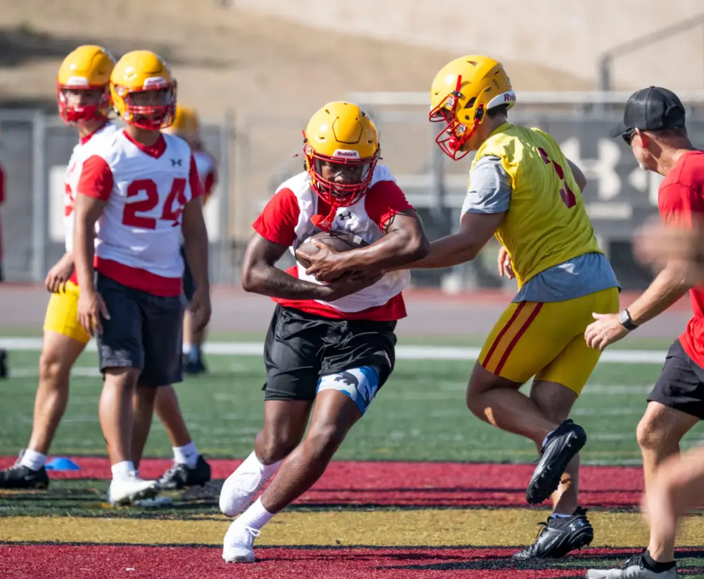 Mission Viejo High School quarterback Brett Burnor (3) practices with...