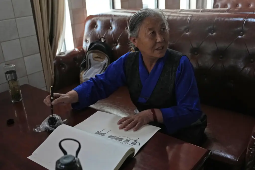 Kalsang Lhamo, a 73-year-old retired nurse, practices Tibetan calligraphy.
