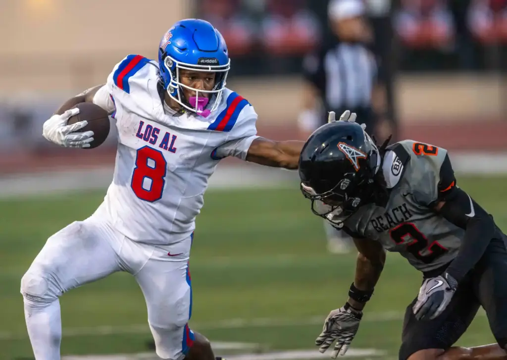 Los Alamitos running back Kamden Tillis (8) breaks a tackle...