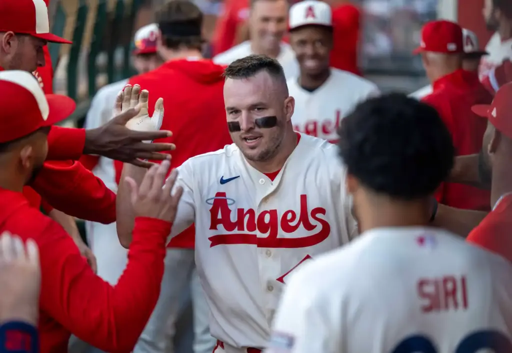 Angels center fielder Mike Trout (27) is congratulated by teammates...