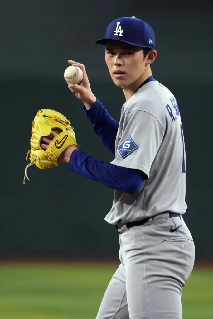Dodgers starting pitcher Roki Sasaki stands on the mound during...