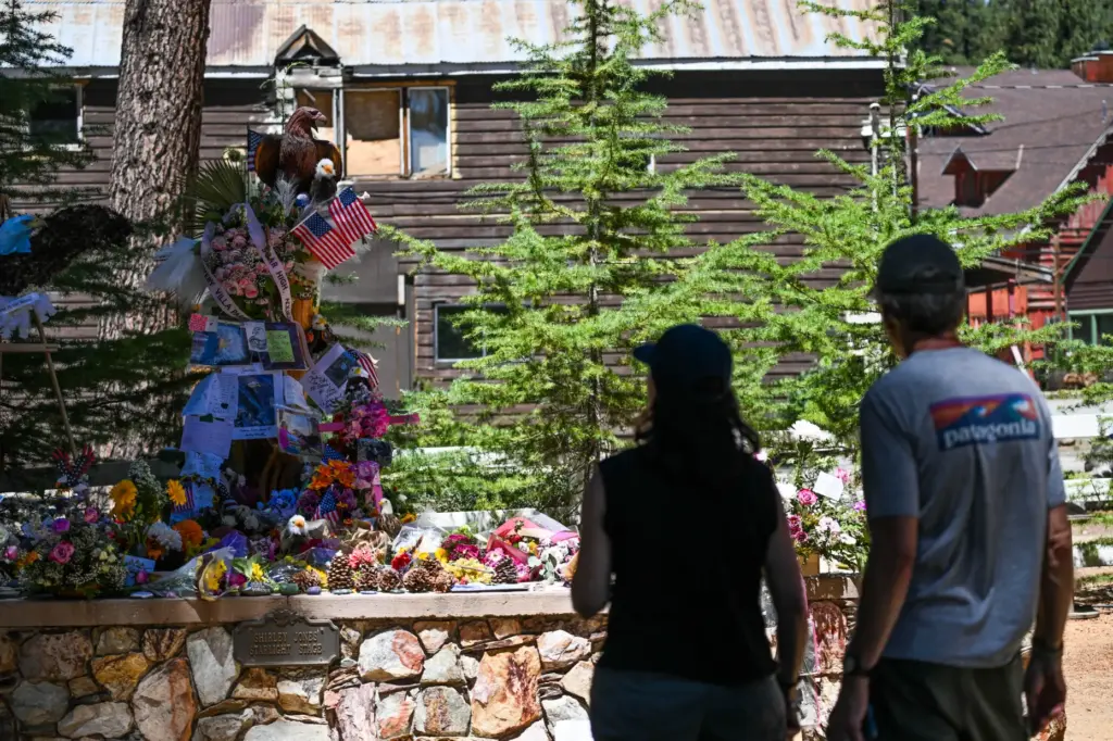 Guests vist the memorial for Jackie, the Big Bear bald...